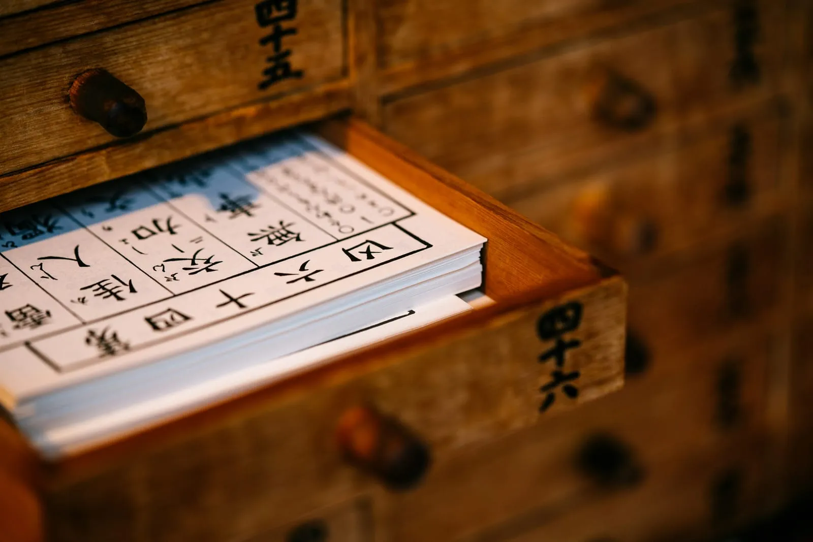 An old wooden drawer filled with calligraphed slips